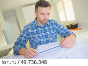 architect man working with blueprints. Стоковое фото, агентство Ingram Publishing / Фотобанк Лори