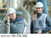 hesitant senior workman on telephone on worksite. Стоковое фото, агентство Ingram Publishing / Фотобанк Лори
