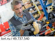 man fixing an outdoor equipment. Стоковое фото, агентство Ingram Publishing / Фотобанк Лори