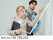 agent showing window blinds to client visiting property. Стоковое фото, агентство Ingram Publishing / Фотобанк Лори
