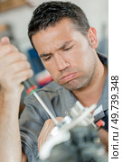 a mechanic is with a frustrated expression. Стоковое фото, агентство Ingram Publishing / Фотобанк Лори