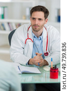 handsome young doctor at work in his office. Стоковое фото, агентство Ingram Publishing / Фотобанк Лори