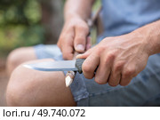 close-up of male hands sharpening pencil with a knife. Стоковое фото, агентство Ingram Publishing / Фотобанк Лори