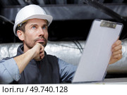 man builder checking electrical installation. Стоковое фото, агентство Ingram Publishing / Фотобанк Лори