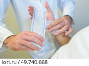 a man treating a minor wound. Стоковое фото, агентство Ingram Publishing / Фотобанк Лори