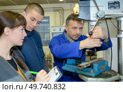 apprentices working on the machine - metal processing. Стоковое фото, агентство Ingram Publishing / Фотобанк Лори
