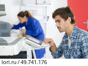 man using control pad on printer. Стоковое фото, агентство Ingram Publishing / Фотобанк Лори