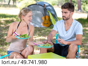 man refusing salad meal on camping trip. Стоковое фото, агентство Ingram Publishing / Фотобанк Лори