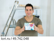 man showing house model isolated on white. Стоковое фото, агентство Ingram Publishing / Фотобанк Лори