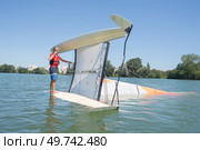 salior trying to right his catamaran after capsize. Стоковое фото, агентство Ingram Publishing / Фотобанк Лори