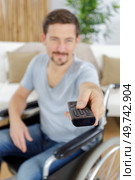 disabled man watching tv at home. Стоковое фото, агентство Ingram Publishing / Фотобанк Лори