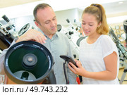 Man and lady looking at professional telescopes. Стоковое фото, агентство Ingram Publishing / Фотобанк Лори