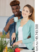 cute young mixed couple preparing. Стоковое фото, агентство Ingram Publishing / Фотобанк Лори