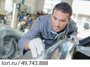 Mechanic sanding down a bumper. Стоковое фото, агентство Ingram Publishing / Фотобанк Лори