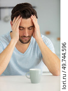 young man having breakfast unhappy and frustrated. Стоковое фото, агентство Ingram Publishing / Фотобанк Лори