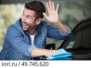 handsome man is washing car outdoor waving hand. Стоковое фото, агентство Ingram Publishing / Фотобанк Лори
