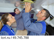 happy female mechanic fixing an airplane. Стоковое фото, агентство Ingram Publishing / Фотобанк Лори