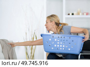 female in wheelchair in laundry. Стоковое фото, агентство Ingram Publishing / Фотобанк Лори