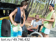 man in wheelchair with friends at the beach. Стоковое фото, агентство Ingram Publishing / Фотобанк Лори