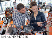 a couple getting a motorbike. Стоковое фото, агентство Ingram Publishing / Фотобанк Лори