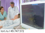 Closeup of observations screen, patient in background. Стоковое фото, агентство Ingram Publishing / Фотобанк Лори