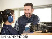 young male and female technicians in metalworks factory. Стоковое фото, агентство Ingram Publishing / Фотобанк Лори