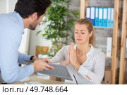 beautiful businesswoman meditating at workplace ignoring colleague. Стоковое фото, агентство Ingram Publishing / Фотобанк Лори