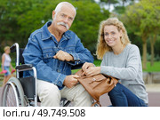 cheerful senior man in wheelchairs with daughter. Стоковое фото, агентство Ingram Publishing / Фотобанк Лори