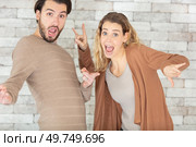 portrait of a funny love couple doing silly gests. Стоковое фото, агентство Ingram Publishing / Фотобанк Лори
