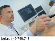 ultrasound technician staring at the patient. Стоковое фото, агентство Ingram Publishing / Фотобанк Лори