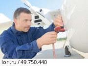 portrait of man doing regular aircraft checkup. Стоковое фото, агентство Ingram Publishing / Фотобанк Лори