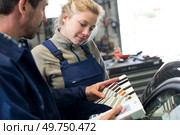beautiful smiling woman mechanic in blue with mentor. Стоковое фото, агентство Ingram Publishing / Фотобанк Лори