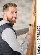 happy handsome cabinetmaker with tools. Стоковое фото, агентство Ingram Publishing / Фотобанк Лори
