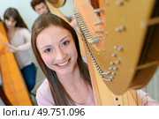 a portrait of female harpist. Стоковое фото, агентство Ingram Publishing / Фотобанк Лори