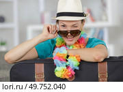 woman winking posing next to suitcase. Стоковое фото, агентство Ingram Publishing / Фотобанк Лори