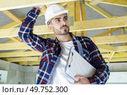 building inspector looking at roof timbers. Стоковое фото, агентство Ingram Publishing / Фотобанк Лори