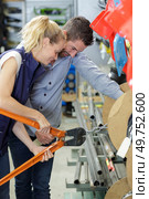 shop assistant cutting length of chain for customer. Стоковое фото, агентство Ingram Publishing / Фотобанк Лори