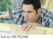 clogging of a nail in wood with hammer. Стоковое фото, агентство Ingram Publishing / Фотобанк Лори