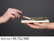 Hand reaching cigarette from mousetrap. Стоковое фото, агентство Ingram Publishing / Фотобанк Лори