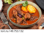 Stewed deer goulash in sauce, venison goulash. Deer ragout on rustic wooden surface.. Roast venison with potatoes. Стоковое фото, агентство Ingram Publishing / Фотобанк Лори
