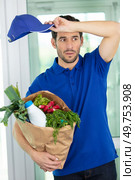 young exhausted deliveryman delivering groceries. Стоковое фото, агентство Ingram Publishing / Фотобанк Лори