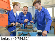 the three machinist at work. Стоковое фото, агентство Ingram Publishing / Фотобанк Лори
