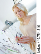 bright blonde tries on glasses. Стоковое фото, агентство Ingram Publishing / Фотобанк Лори