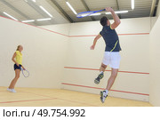 couple with squash rackets indoor training club. Стоковое фото, агентство Ingram Publishing / Фотобанк Лори