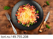 Pasta with fried bacon on a vintage wooden background. Pasta alla carbonara.. Pasta carbonara on wooden table. Стоковое фото, агентство Ingram Publishing / Фотобанк Лори