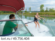 happy woman riding on wakeboarding. Стоковое фото, агентство Ingram Publishing / Фотобанк Лори