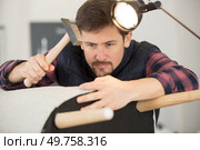 craftsman engaged in chair repair. Стоковое фото, агентство Ingram Publishing / Фотобанк Лори