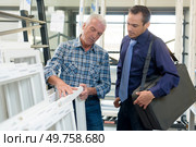 portrait of smiling satisfied worker at pvc windows factory. Стоковое фото, агентство Ingram Publishing / Фотобанк Лори