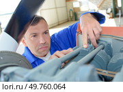 a mechanic in deep concentration. Стоковое фото, агентство Ingram Publishing / Фотобанк Лори