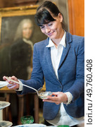 female collector holding antique silver ladle. Стоковое фото, агентство Ingram Publishing / Фотобанк Лори